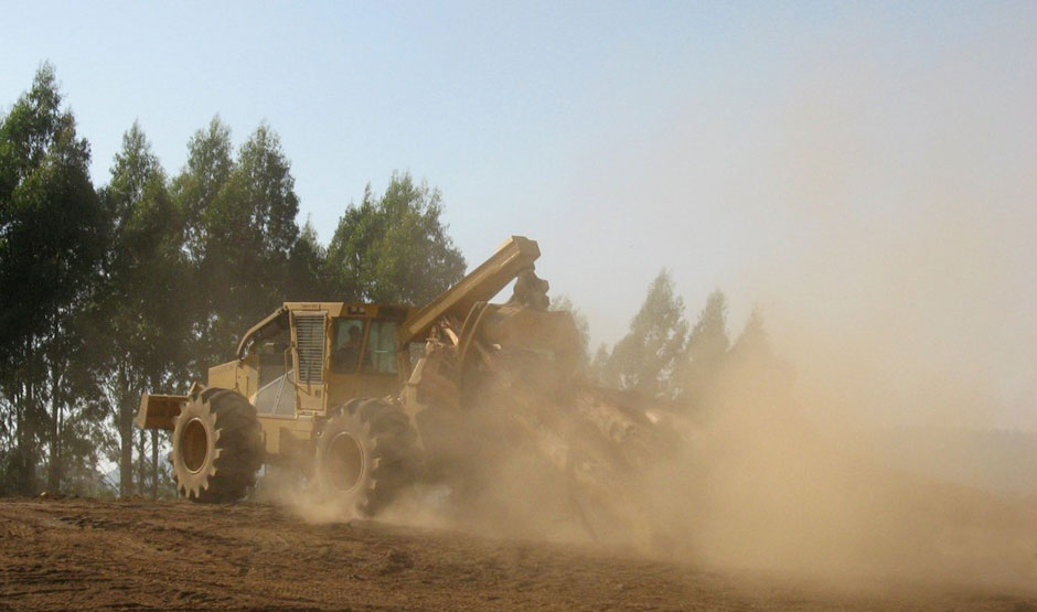 A skidder driving in the dust. When the dust doesn't settle. High levels of airborne debris decrease air filter change intervals and increase the need to check and clean the heat exchangers.