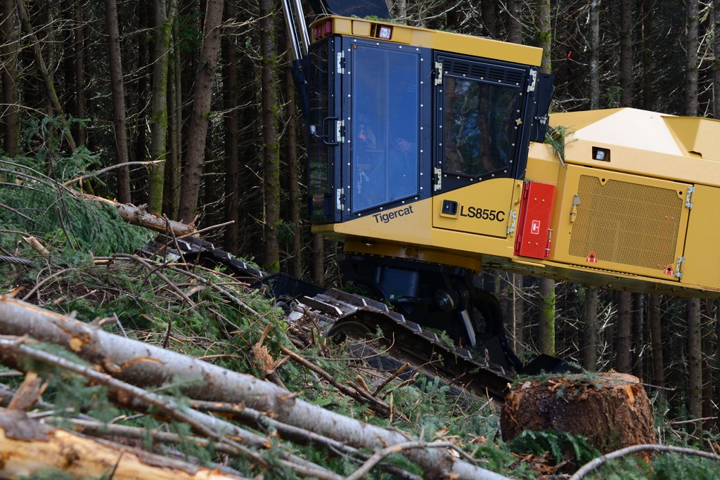 An LS855C climbs a steep slope using cable assist logging technology