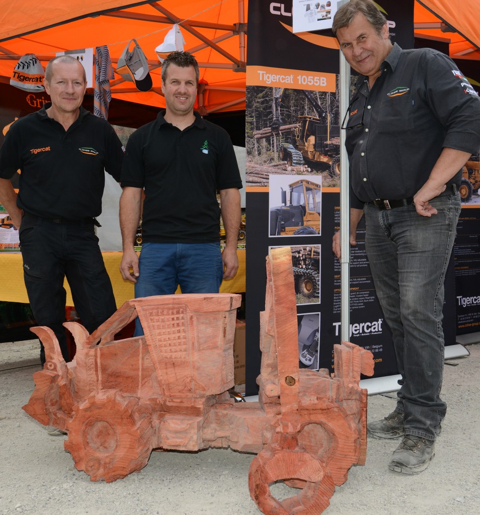 Nicolas Gombert (centre) was so excited about his new skidder, he recreated it in cedar. He is flanked by Clohse Group technical manager, Piers Eyre-Walker (left) and Clohse Group owner Dieter Clohse.