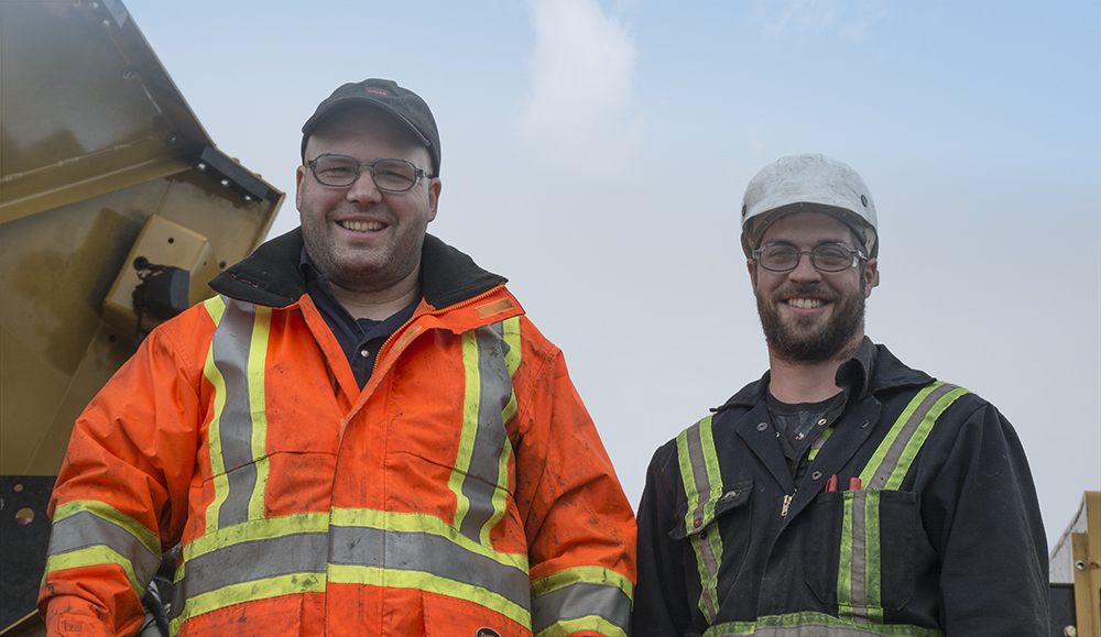 Wajax mechanic, Clancy Allard with Tigercat customer Michael Lavoie, working on his H855C harvester.