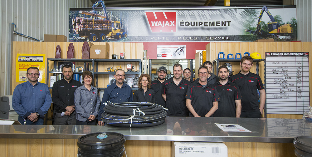The hard working office staff of Wajax Saint-Félicien branch. standing behind a parts counter (L-R): Sylvain, Dominic, Ghislaine, Gilles, Chantale, Bruno, Pierre, Frederic, Denis, Matthieu, Eric, Jonathan.