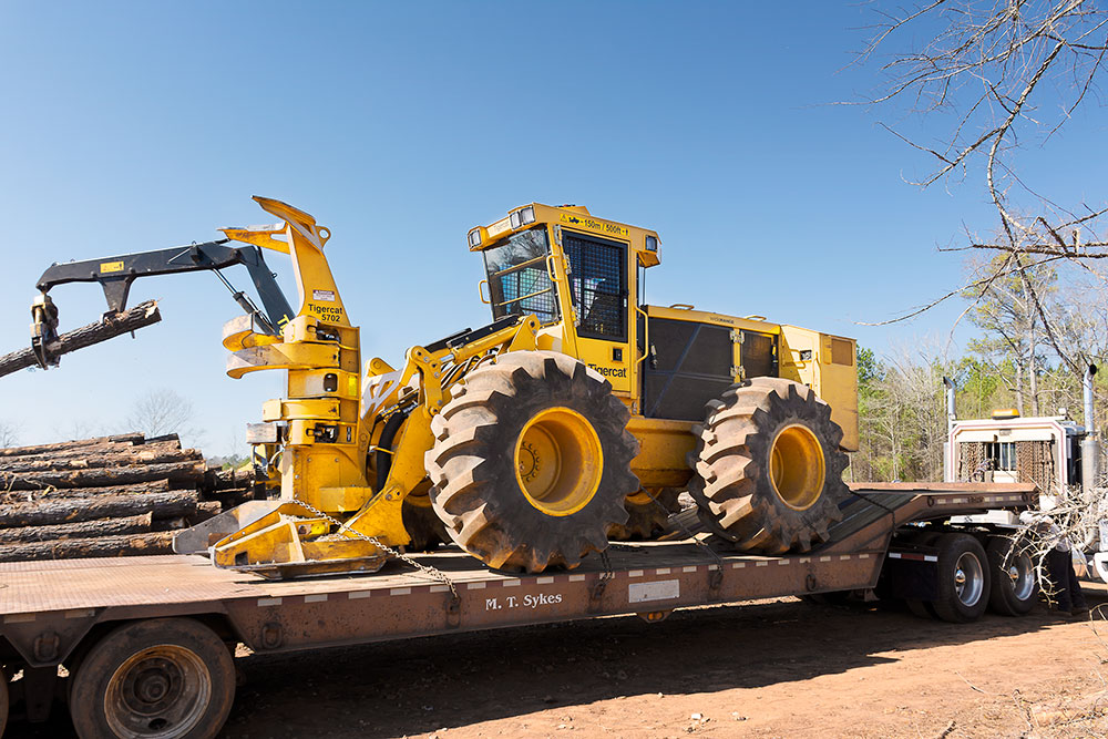 M.T. Sykes had its 724G arrive on-site in February 2017; 724G wheel feller buncher on a truck trailer.