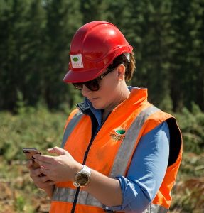 Wendy Fennell attends to logging business on her cell phone.