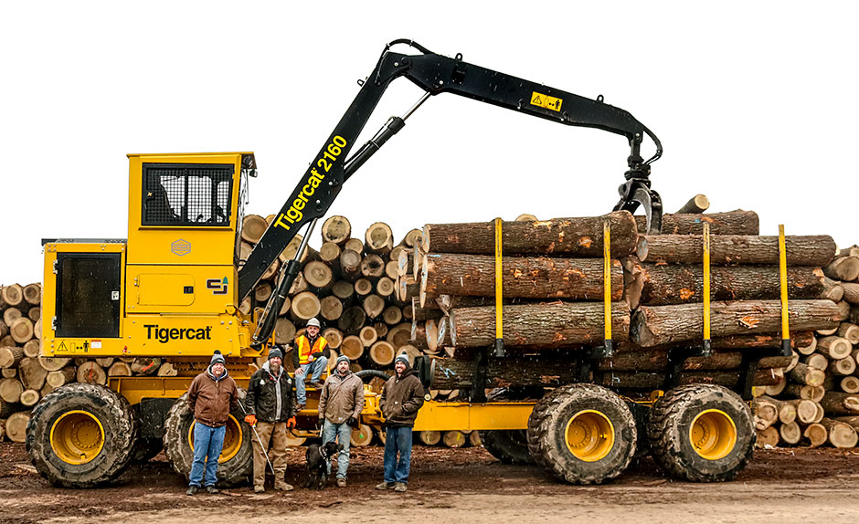 Jerry Smeak, Tigercat district manager; Leo Eby, part owner; John Lovin, 2160 operator; Buster (dog); David Brown, assistant log buyer; Durrel Eby, part owner standing in front of the 2160