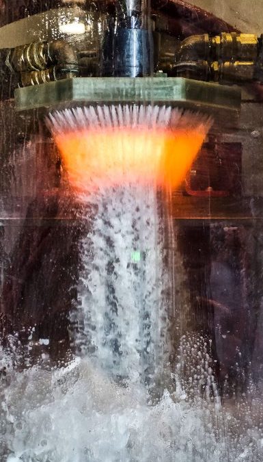 A Tigercat spindle goes through the heat treat process. Quenching the part retains the desired hardness.