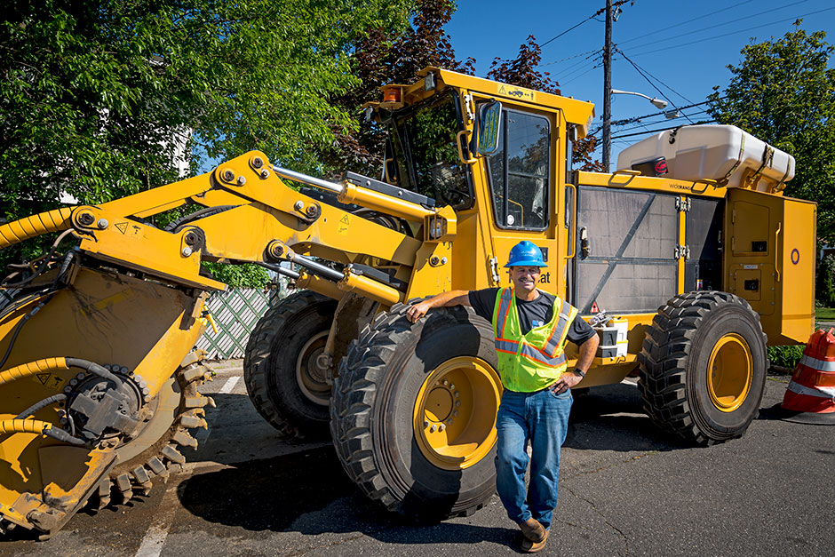 Mike Martino, a lead engineer at Asplundh Construction, in front of a Tigercat T726G trencher.