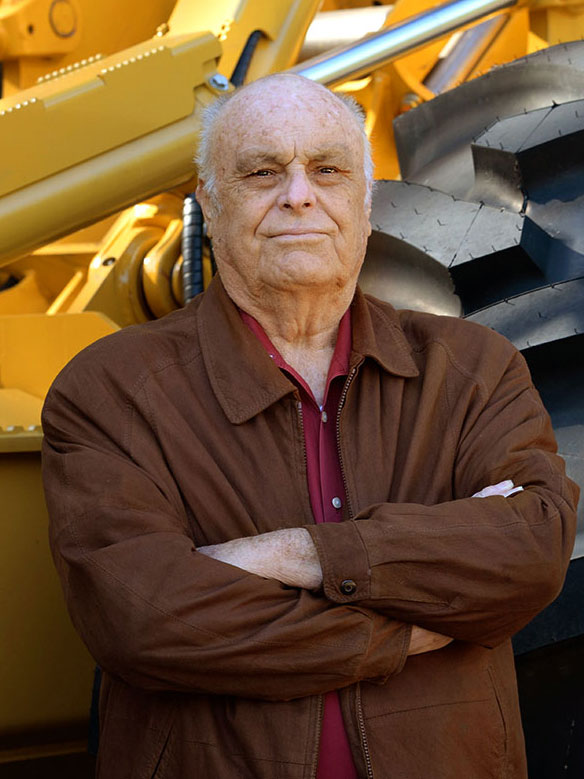 W.J. Bates, co-founder of B & G Equipment in front of a Tigercat skidder.