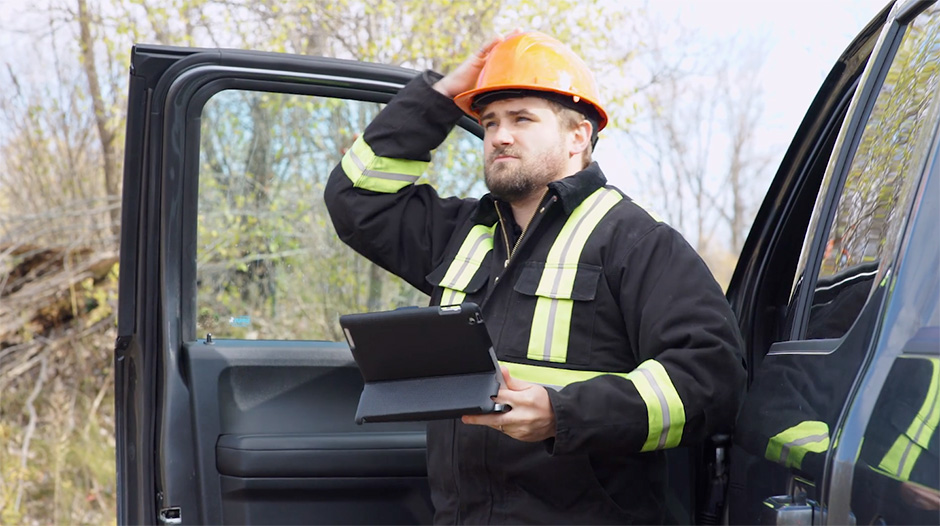 Logger exiting truck with tablet