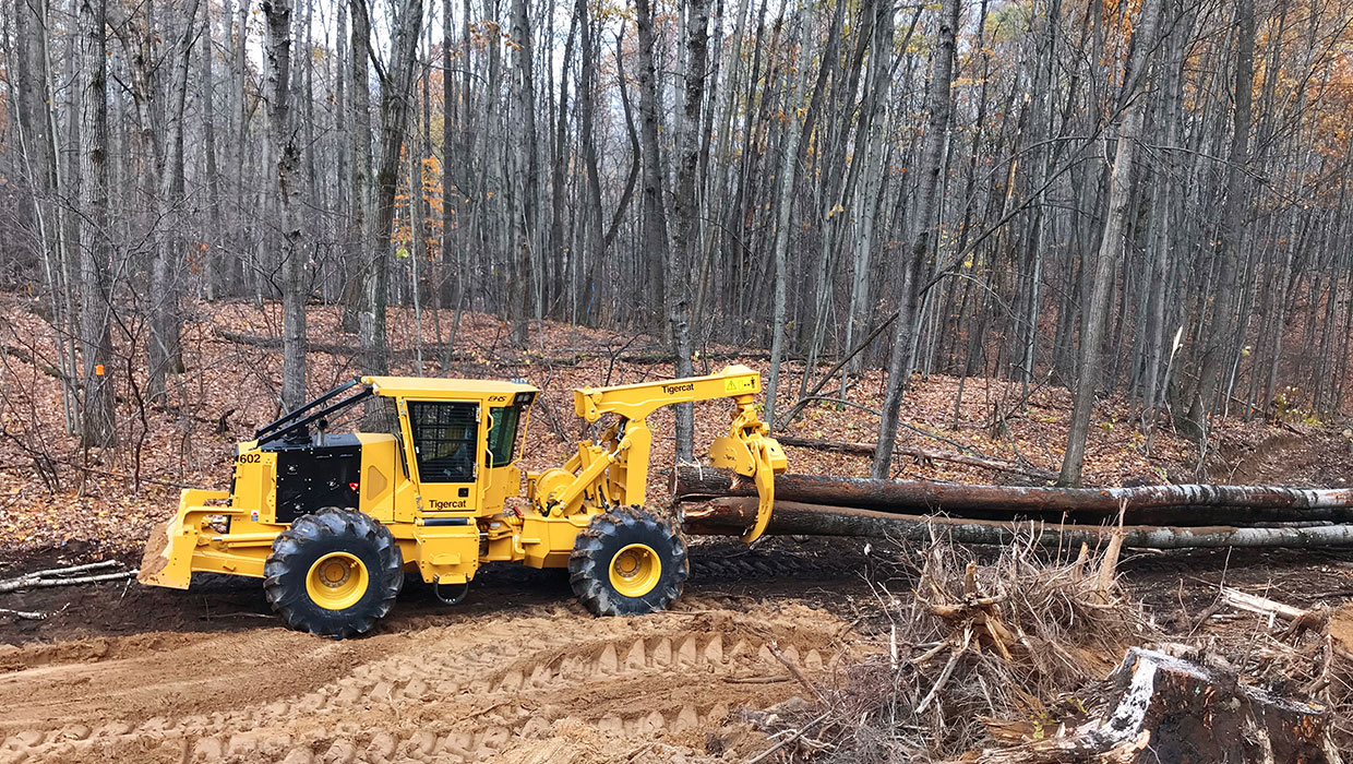 Image of a Tigercat 602 grapple skidder working in the field