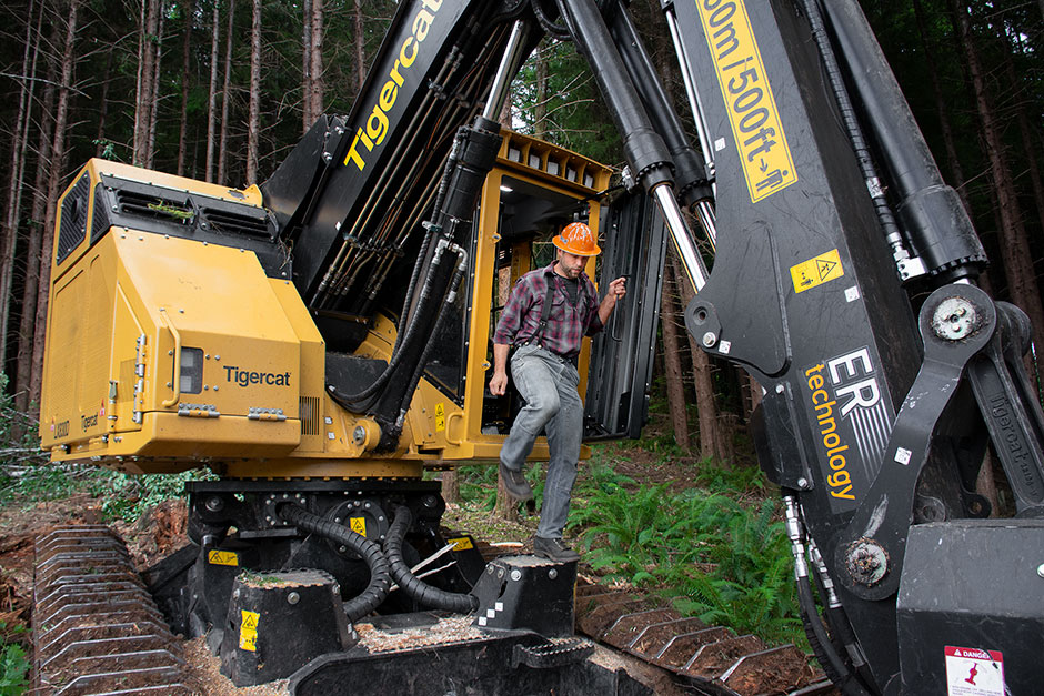 Adam Zepp exiting the cab of the LX830D feller buncher