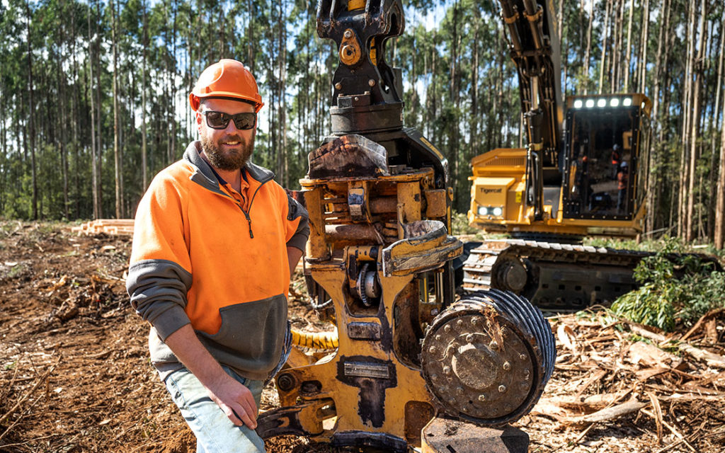 Fielding Logging operator standing in front of the Tigercat 570 harvesting head