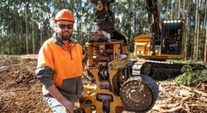 Fielding Logging operator standing in front of the Tigercat 570 harvesting head