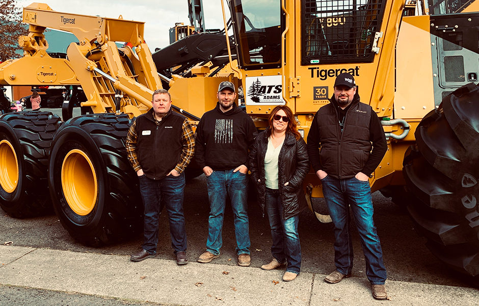 Brian Davis (Triad territory manager) with Adam and Breanna Lee, and Jason Lee in front of the latest skidder to join the fleet of Adam’s Timber Service.