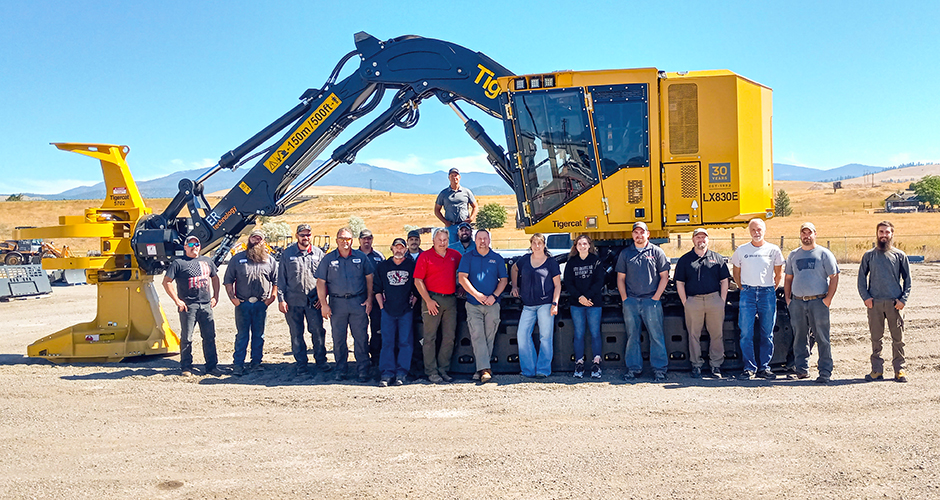 Torgerson's team in front of a tigercat LX830E feller buncher