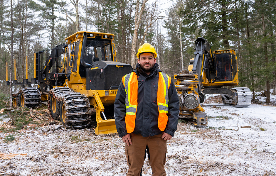 Man standing in front of Tigercat machines.