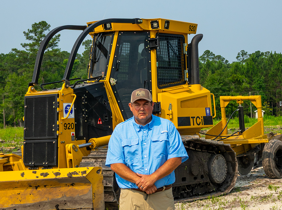 Chris Moss, Fire Chief standing in front of the Long County Fire Department owned TCi 920 dozer.