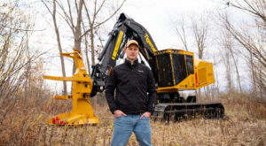 A Tigercat engineer in front of a Tigercat machine