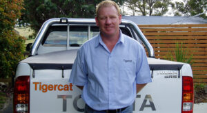 Photo of Steve Green in front of a Tigercat truck