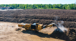 Image of a Tigercat 6900 grinder processing yard waste.